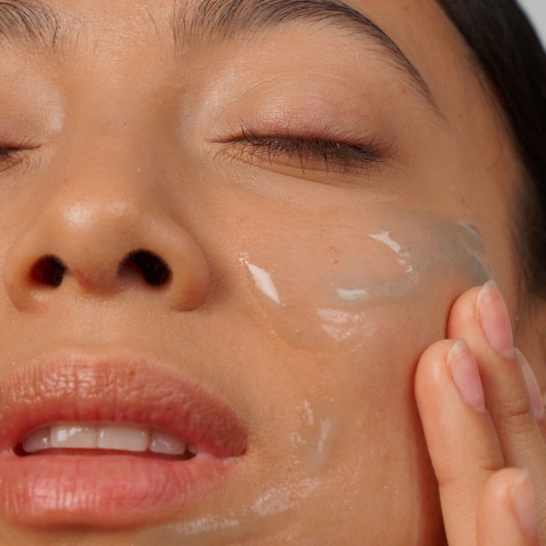 girl applying gel to her face